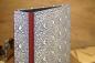 Preview: Folder Carta Varese dove motif blue and white, Linen edges of burgundy linen